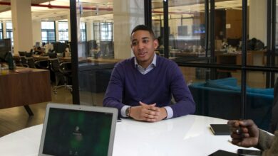 a man sitting at a table with a laptop